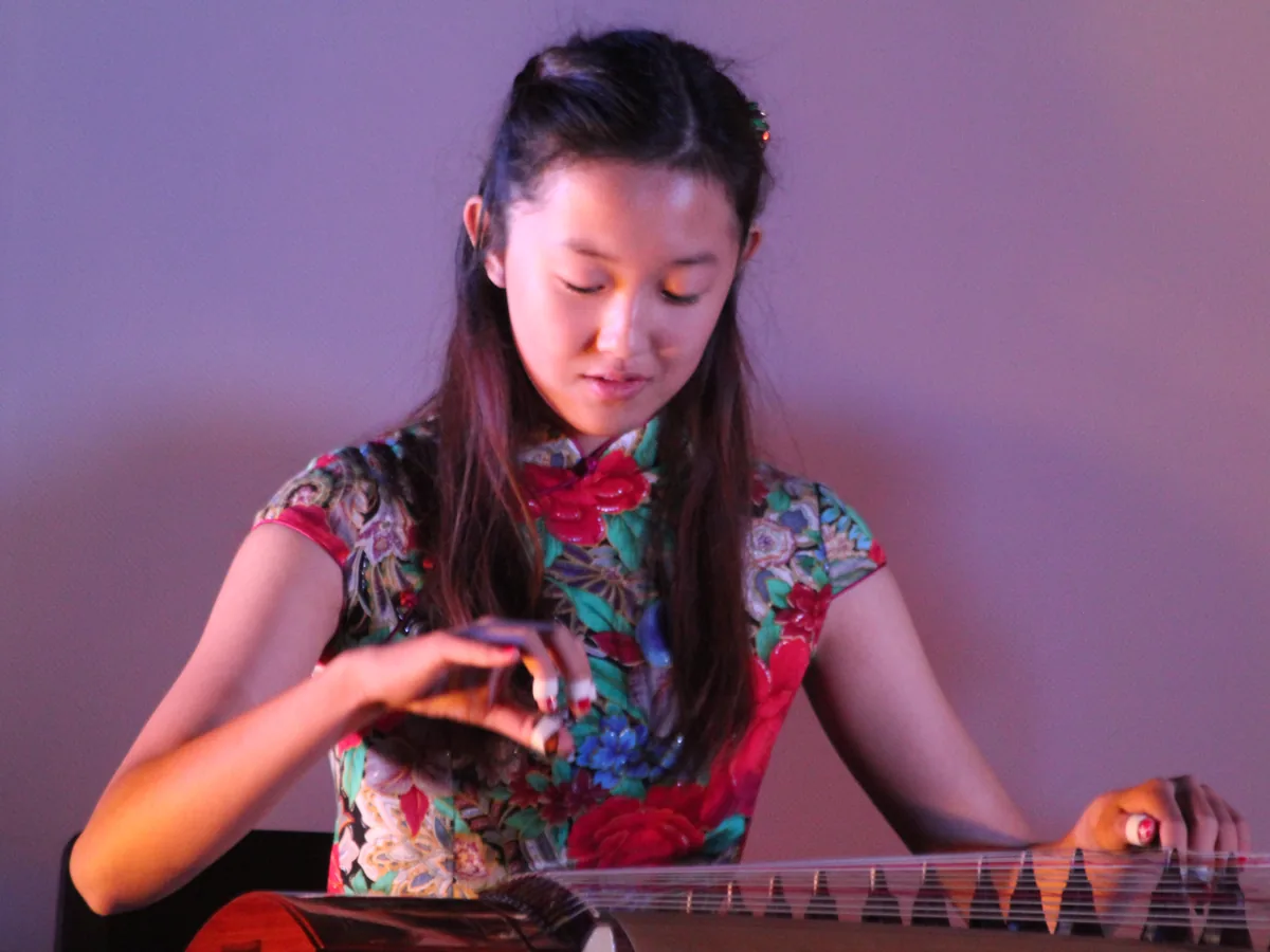 Musicians performing on the guzheng, a Chinese zither